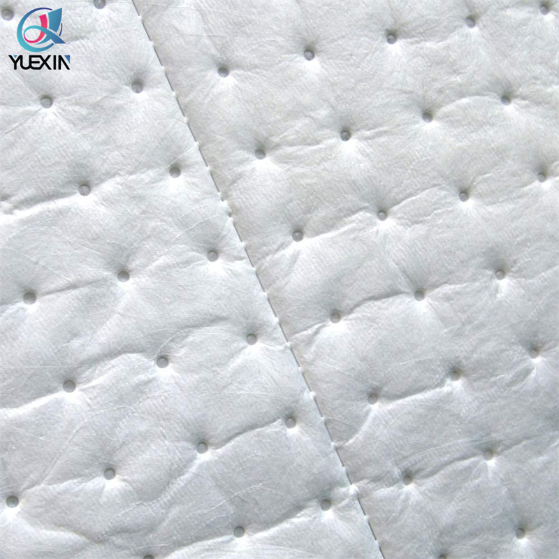 Oil absorbent pad deployed on an industrial spill